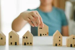 Woman,Selecting,And,Arranging,Wooden,House,Models,,Concept,Of,Real Woman,Selecting,And,Arranging,Wooden,House,Models,,Concept,Of,Real